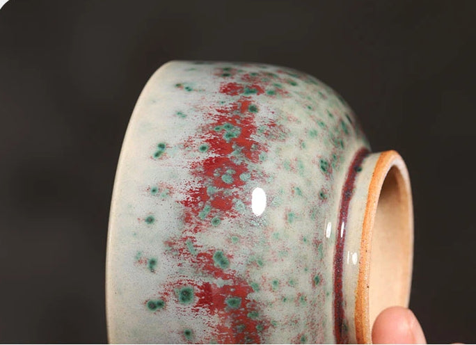 Macro shot of the Phoenix Tail glaze effect on a handcrafted Jun Ware ceramic teacup.