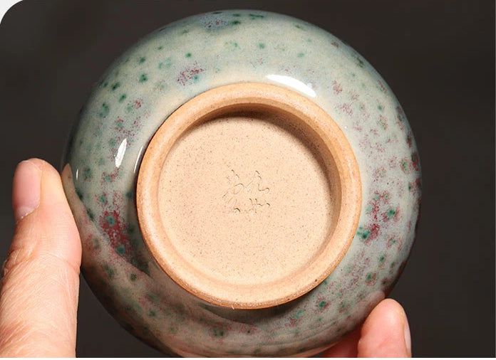 Close-up of the unglazed bottom foot ring on a handcrafted Jun Ware Luohan teacup.