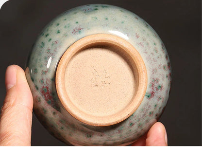 Close-up of the unglazed bottom foot ring on a handcrafted Jun Ware Luohan teacup.