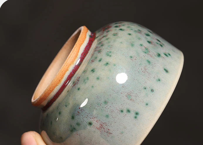 Side profile of a 120ml handcrafted Jun Ware Luohan teacup highlighting its rounded shape.