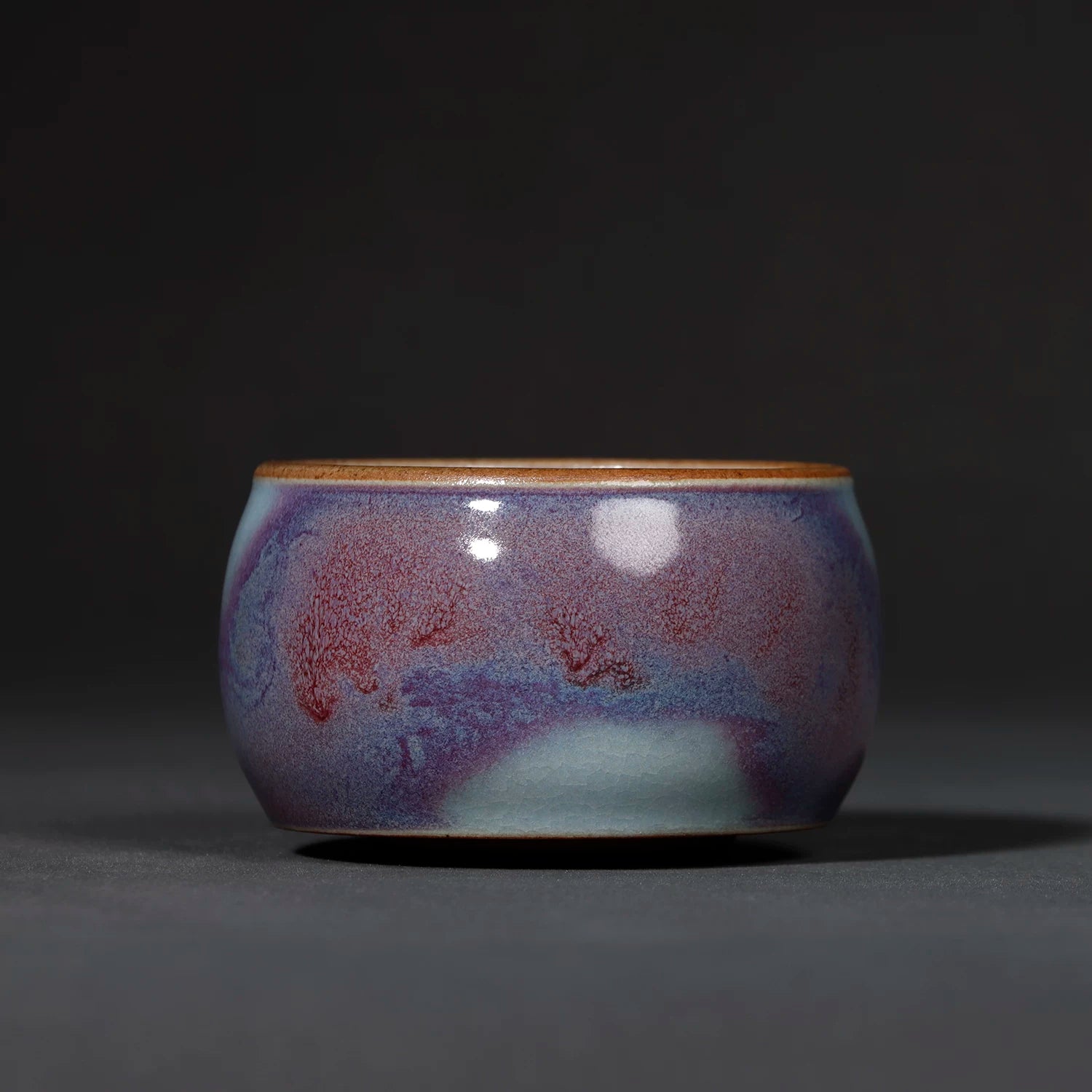 Close-up of the vivid Starry Galaxy Violet glaze and starry mottled pattern on the Jun ware teacup.