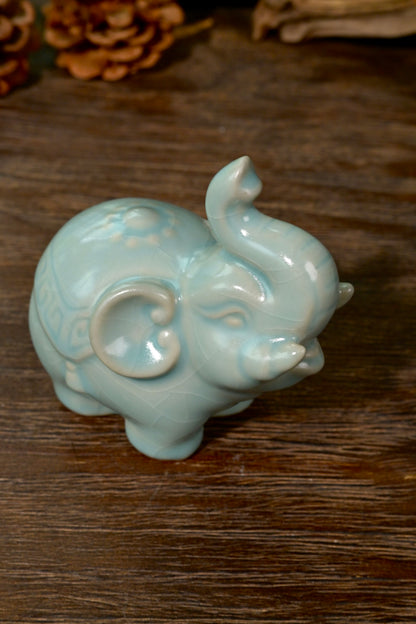 Side profile of Ru kiln sky-blue elephant tea pet showing sculpted saddle blanket detail