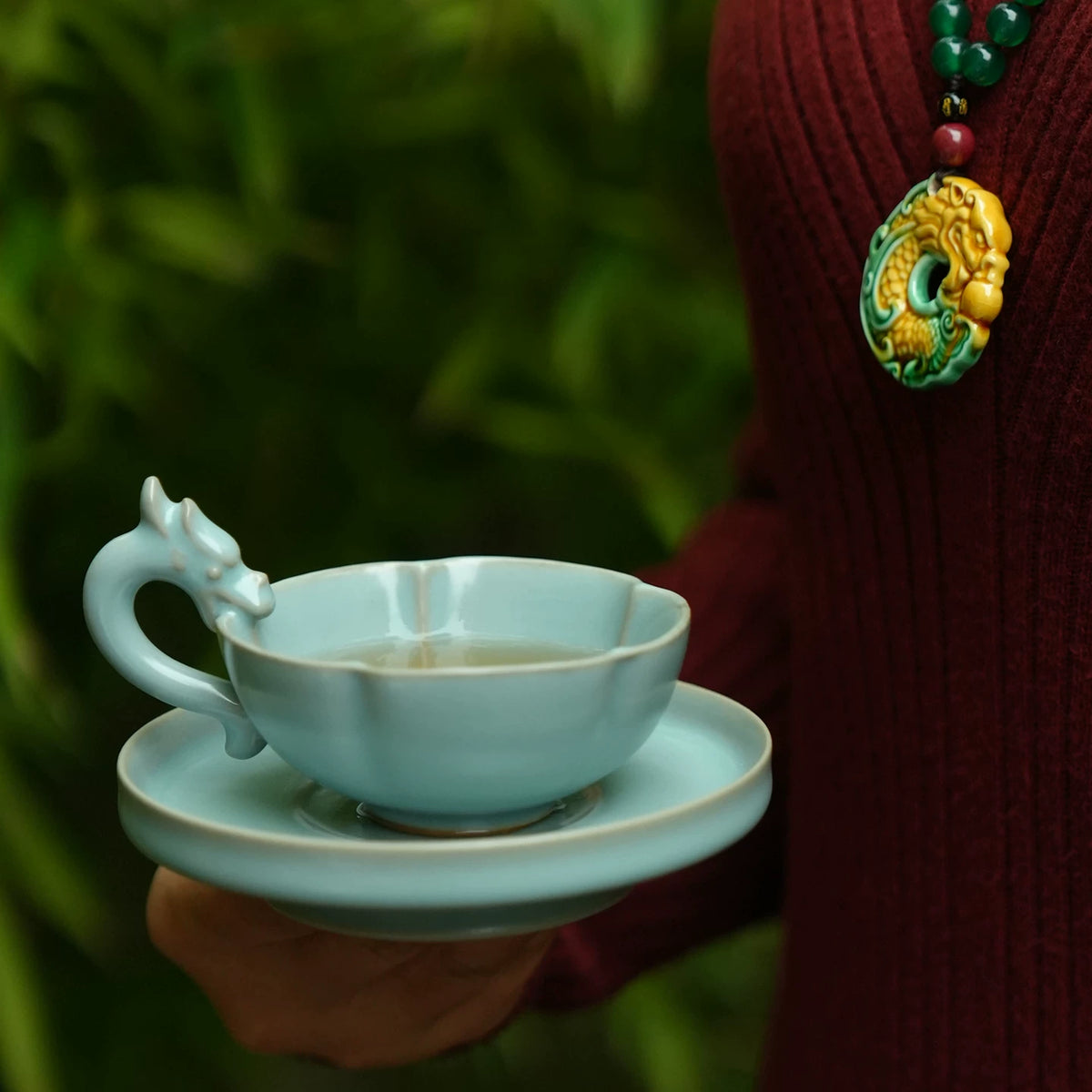 Side profile of 85ml Ru kiln sky-blue dragon cup showing six-lobed rim and iron rim detail