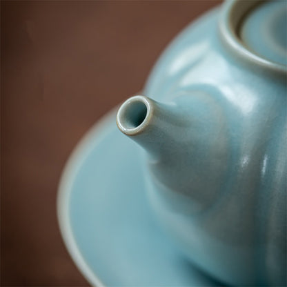 Side profile of 200ml Ru kiln sky-blue pumpkin teapot showing ergonomic loop handle and pouring spout