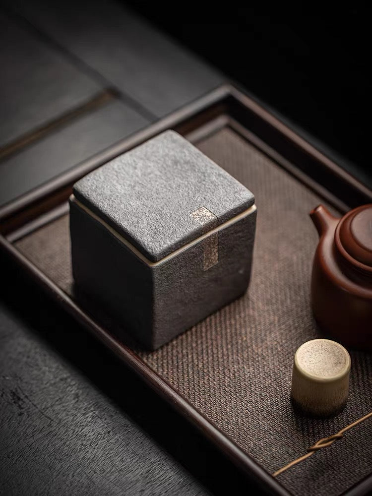 Handcrafted tea caddy with unglazed rough clay body and intentional imperfections
