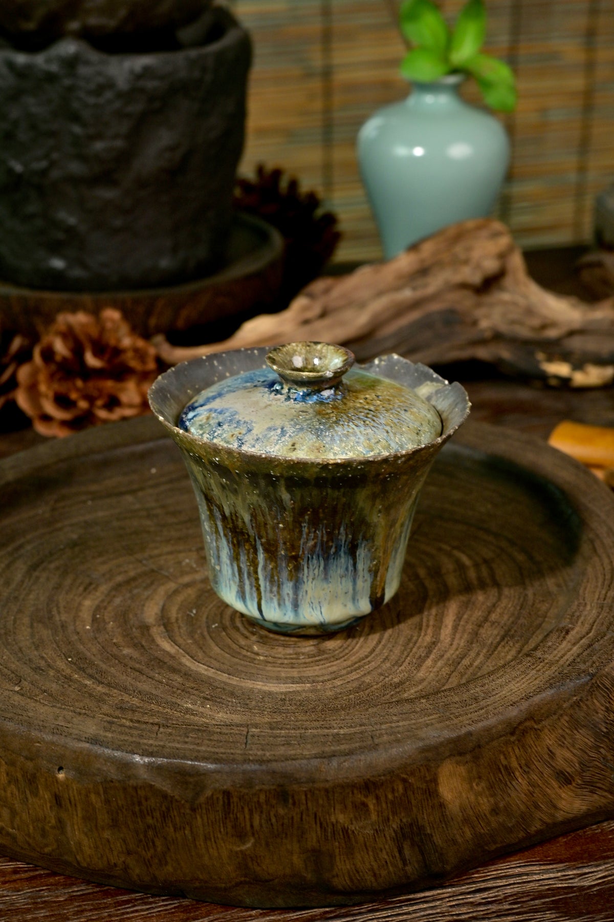 Artisanal wood-fired gaiwan 150ml displaying rough stoneware texture and cascading natural glazes