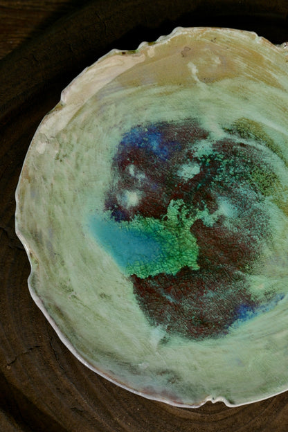 One-of-a-kind soda-fired irregular tea coaster plate displayed on wooden easel stand