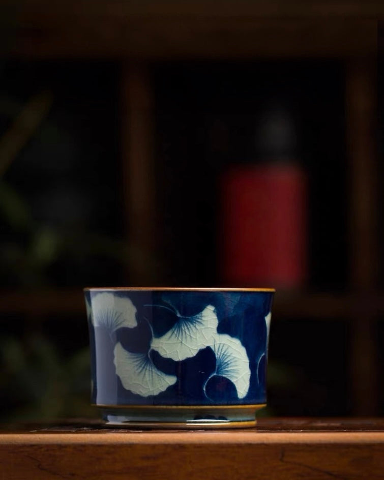 Hand‑painted ginkgo leaf motif on vintage Jingdezhen teacup, underglaze blue artwork