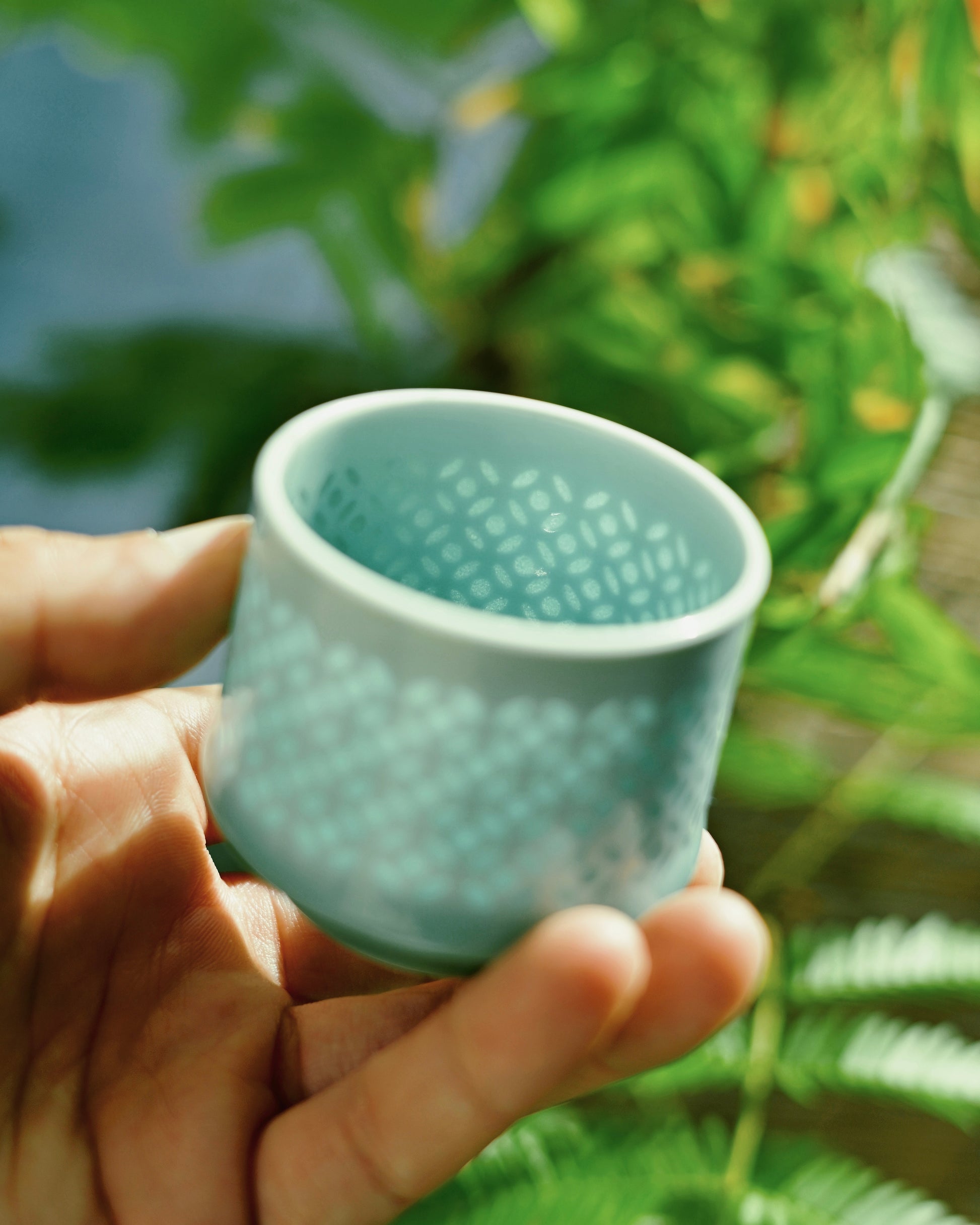 Close-up of delicate floral motifs created using traditional Linglong porcelain technique