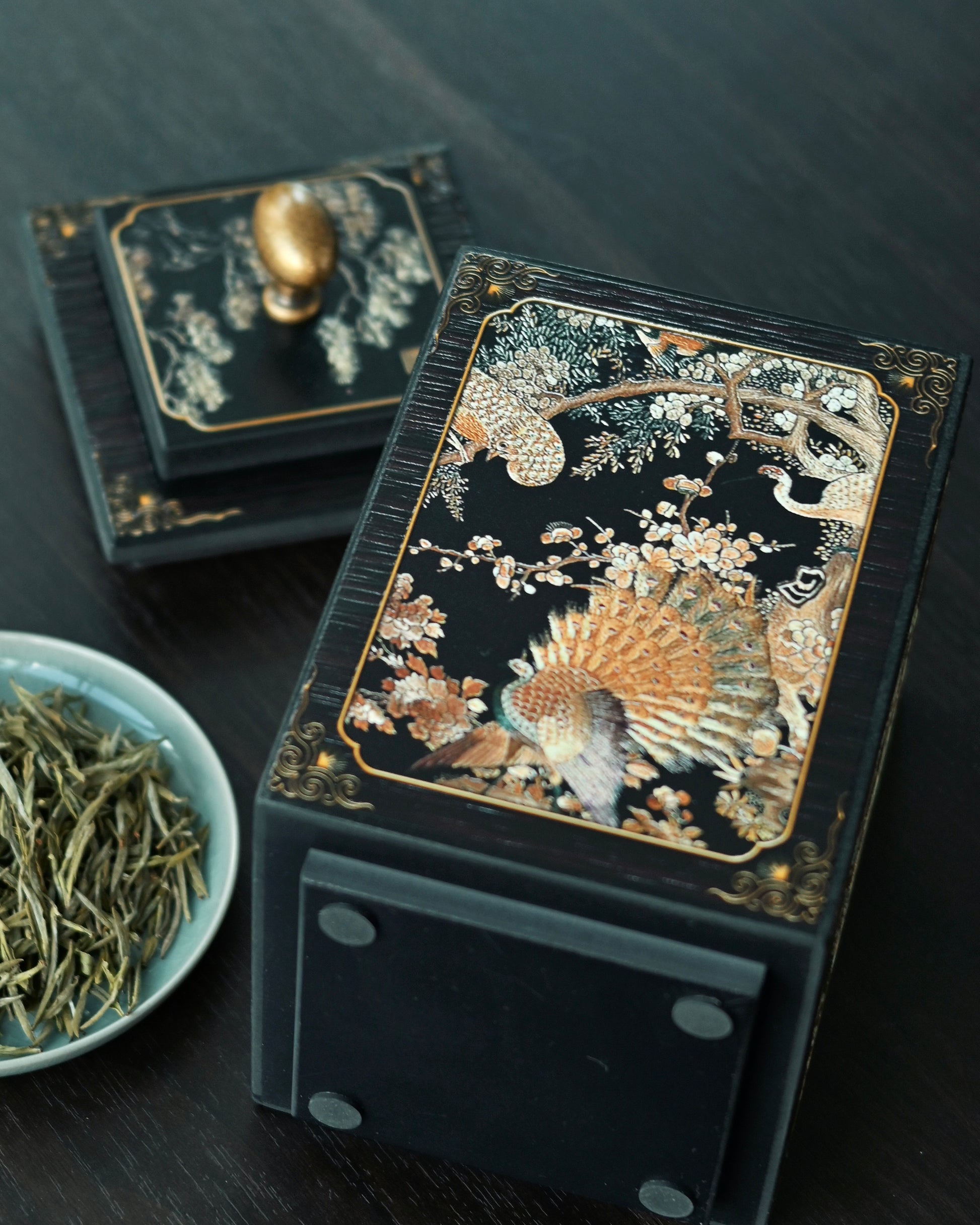 Ornate tea storage jar with deep relief carving showing imperial phoenix surrounded by various bird species