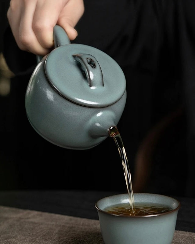 Longquan celadon teapot crafted from iron clay with glossy celadon surface