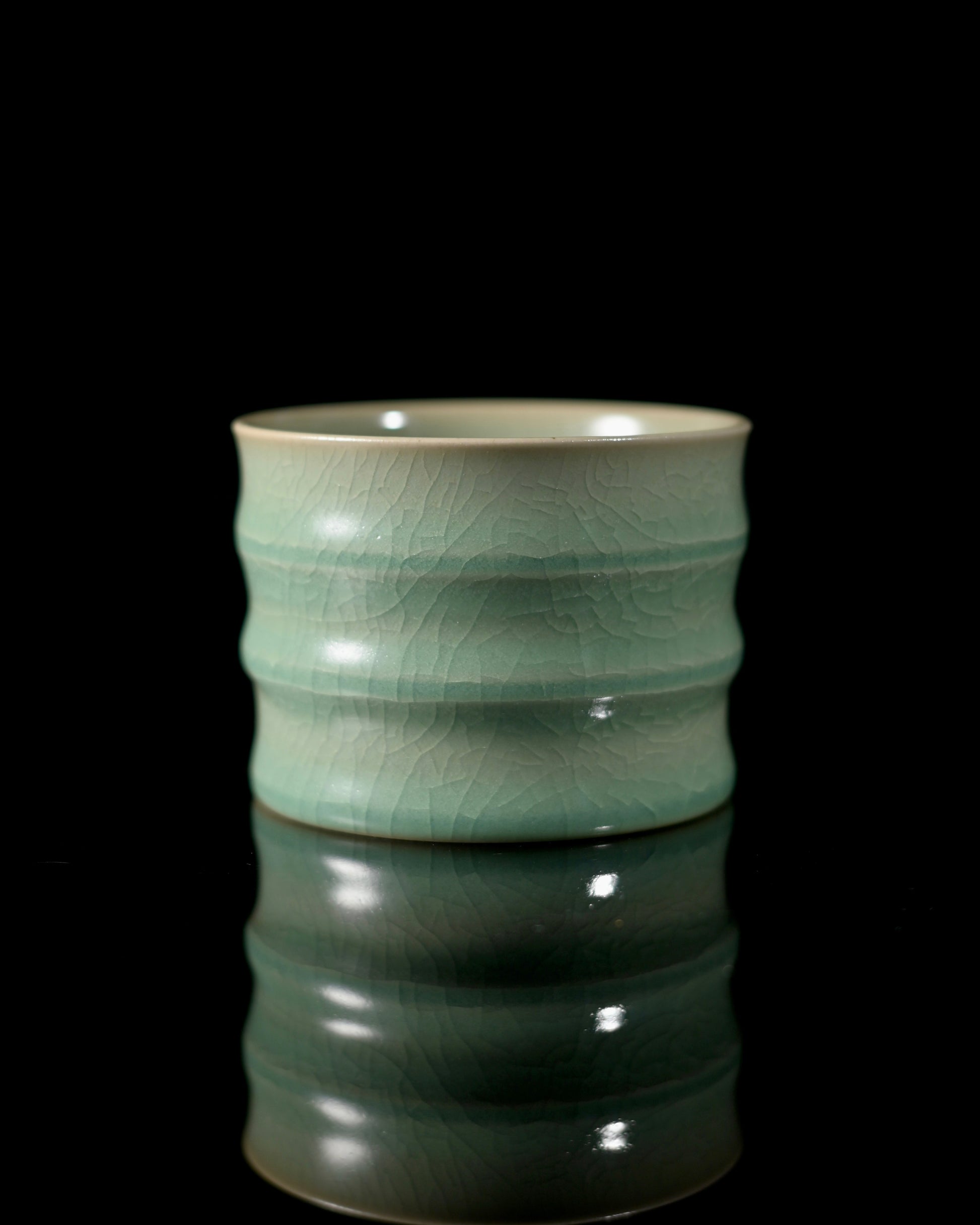 Jadeite-glazed Ru ware cup with bamboo joint design, combining ancient crackle artistry with modern functionality