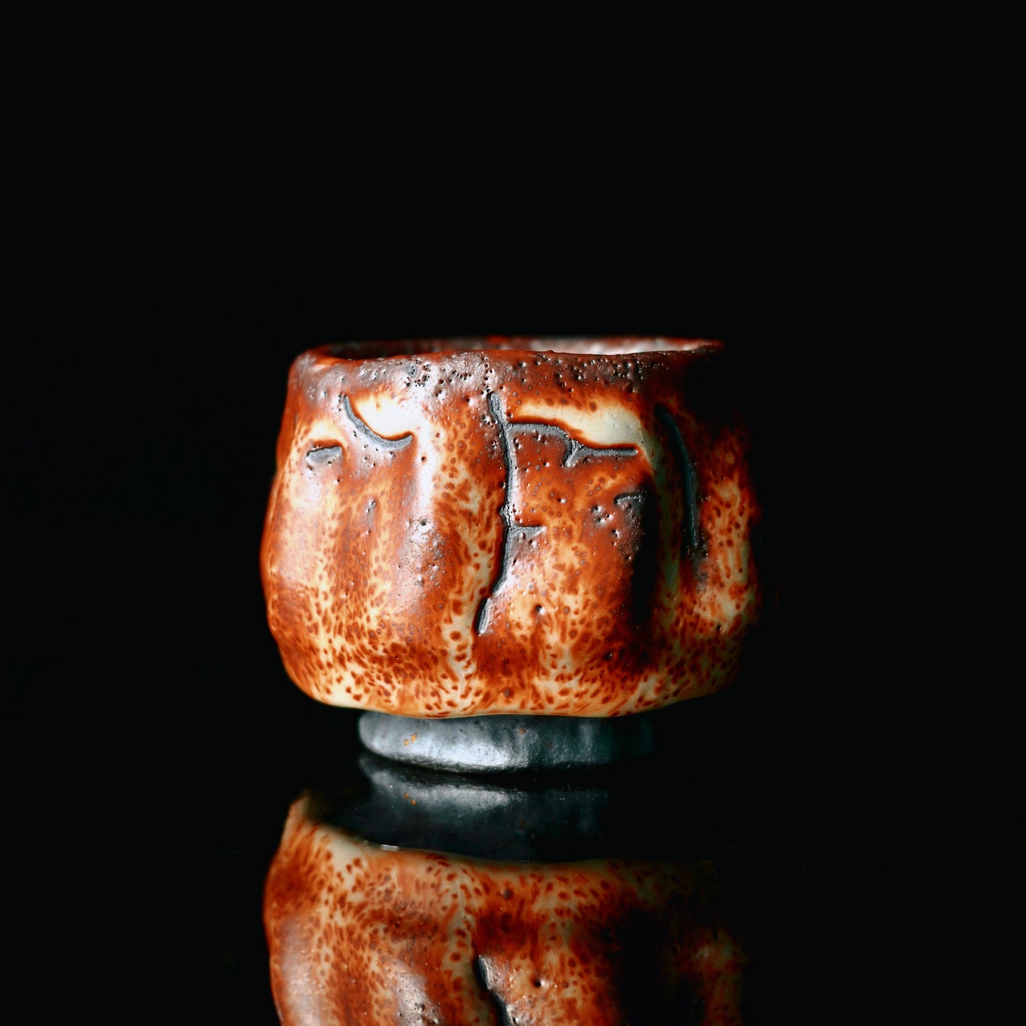 Japanese Mino ceramic ware teacup with ruby red kiln-transformed glaze and natural pinhole texture