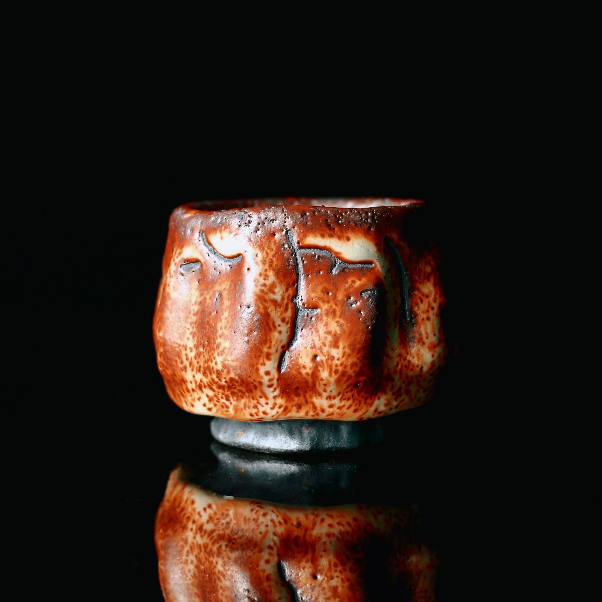 Japanese Mino ceramic ware teacup with ruby red kiln-transformed glaze and natural pinhole texture