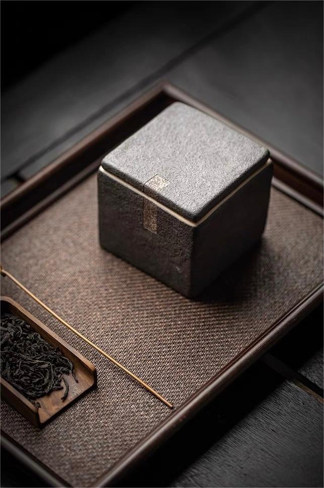 Organic square tea canister with unglazed coarse clay surface and rustic charm