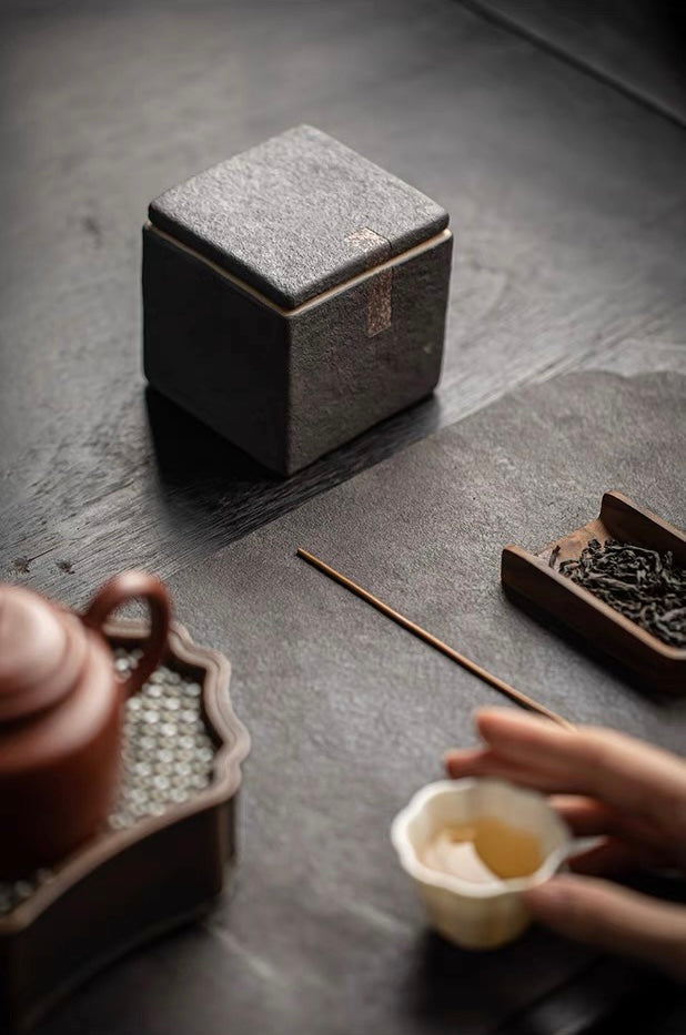 Japanese-style rustic tea caddy with completely unglazed surface and square geometric form