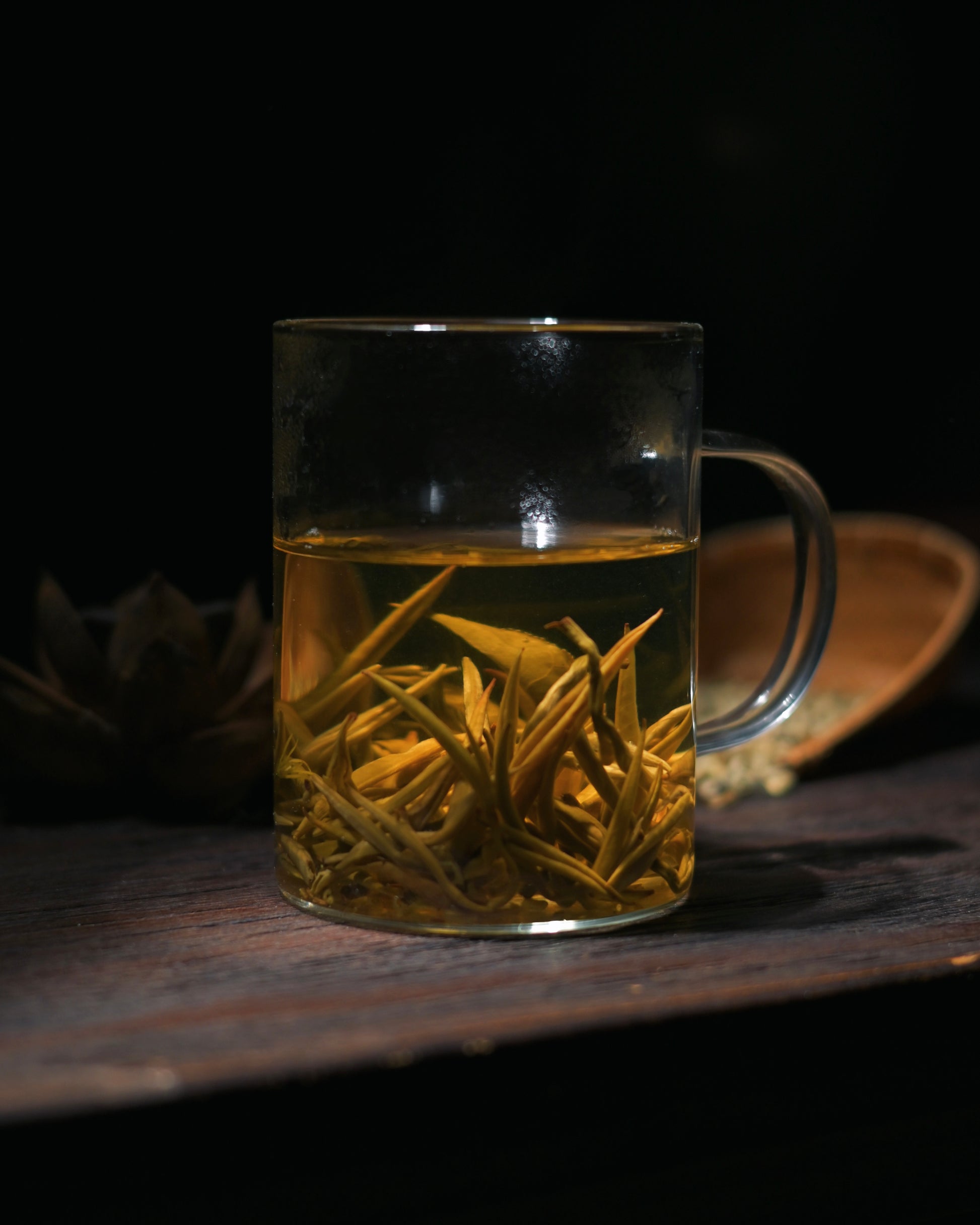 Pale golden liquor of jasmine-scented Silver Needle tea with clear brightness
