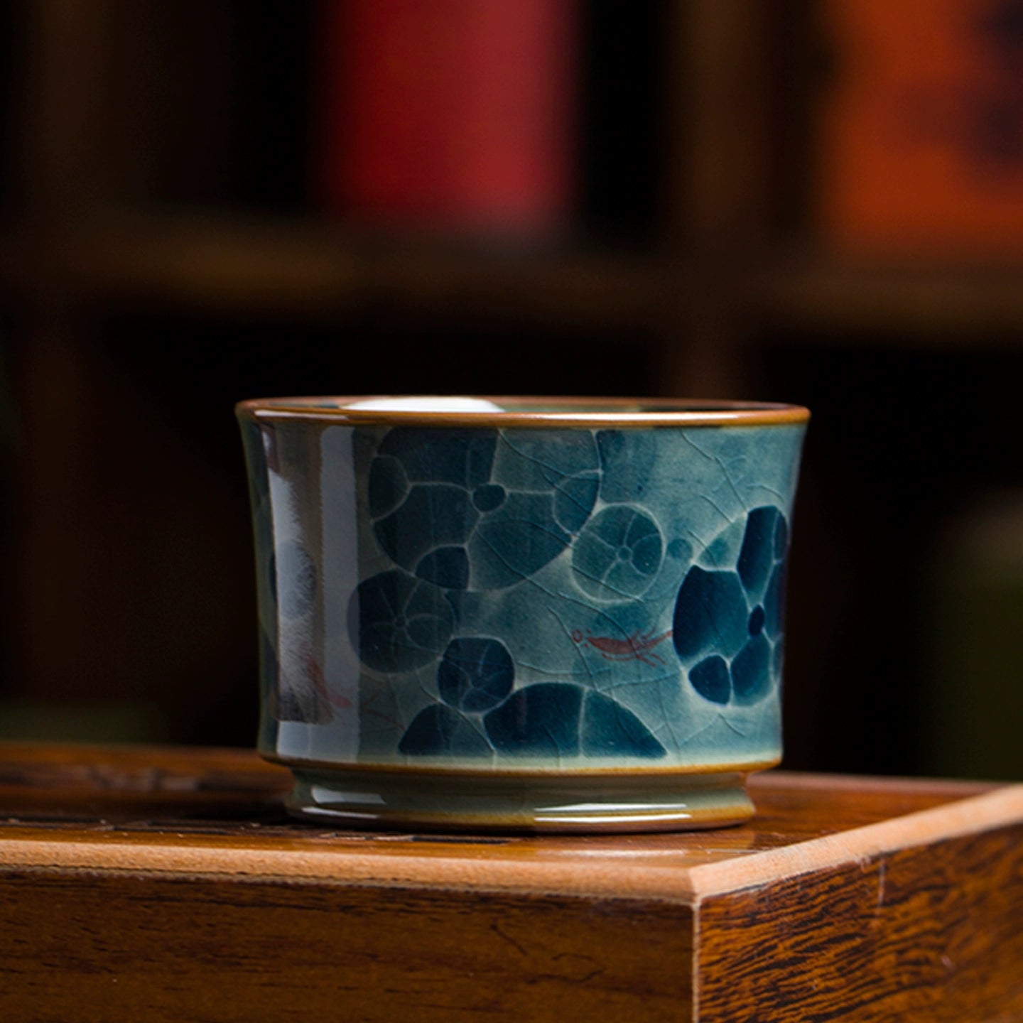 An artisan-made Jingdezhen blue and white underglaze porcelain tea cup decorated with delicate brushstroke patterns, representing authentic traditional porcelain techniques.
