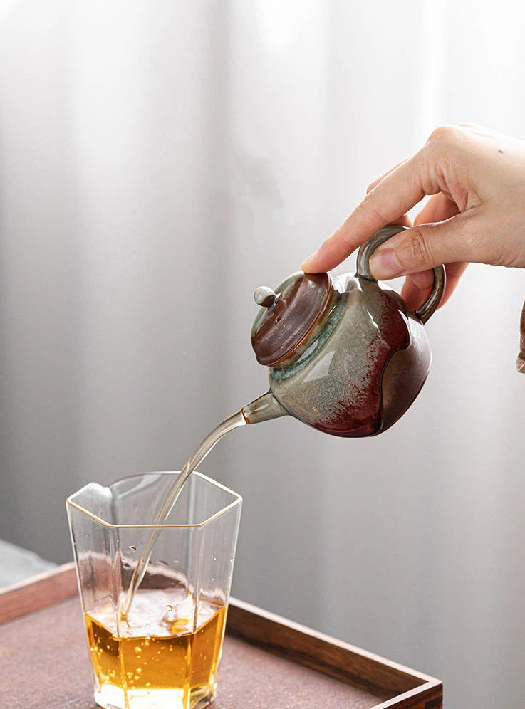 Wood-fired underglaze red teapot showcasing natural ash effects and warm earthy tones