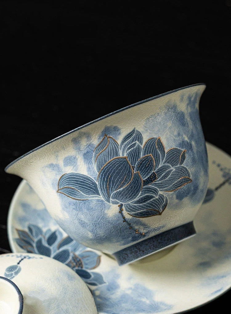 Side profile view showing the elegant silhouette and carved relief texture of the tea set.