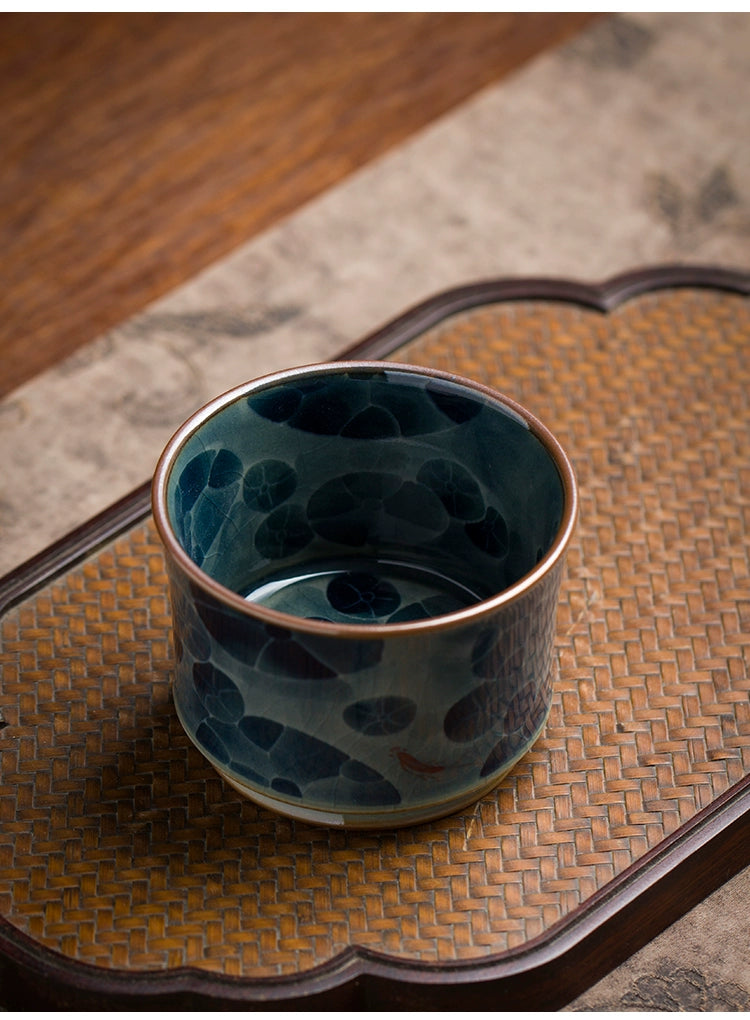 A handcrafted Jingdezhen blue and white underglaze porcelain tea bowl showcasing detailed hand-painting and smooth contours, suitable for both tea brewing and display.