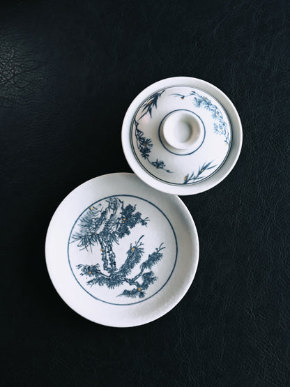 Jingdezhen artisan-crafted Sancai gaiwan featuring precise hand-rendered pine motifs under a velvety matte glaze, wheel-thrown from high-whiteness kaolin clay for optimal tea expression.