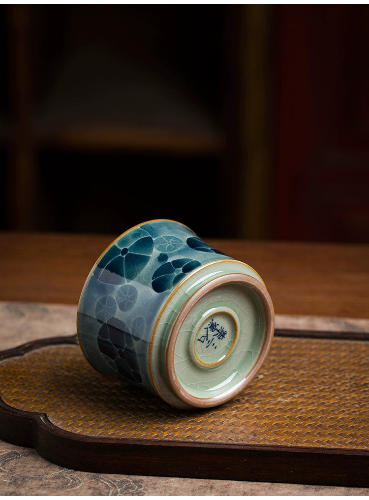 An artisanal Jingdezhen blue and white underglaze porcelain tea cup with intricate cobalt patterns and a polished finish, reflecting centuries of porcelain craftsmanship.