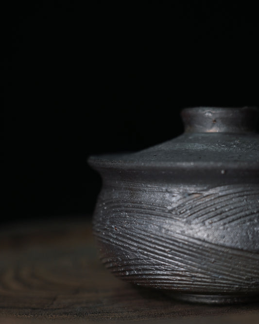 Naked-fired ash deposit surface with areas of natural glass-like glaze from pine wood firing