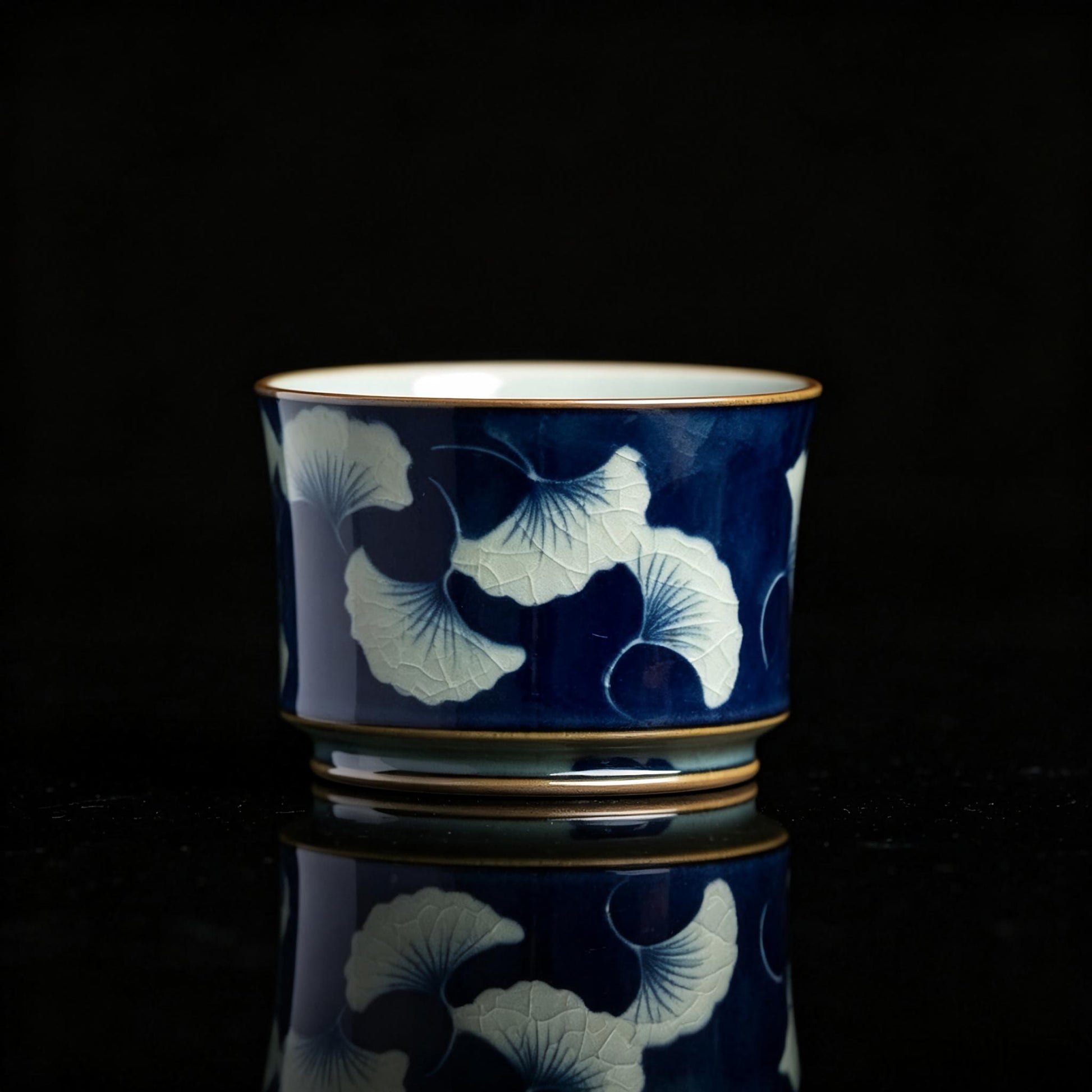Jingdezhen underglaze‑blue teacup with hand‑painted ginkgo leaves, traditional Chinese ceramic craft