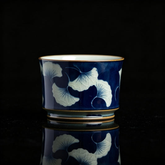 Jingdezhen underglaze‑blue teacup with hand‑painted ginkgo leaves, traditional Chinese ceramic craft