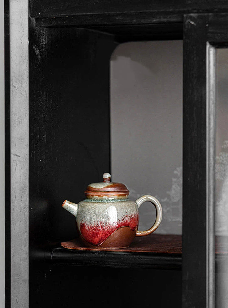 Artisan Jingdezhen teapot featuring crackle textures and flowing red glaze patterns