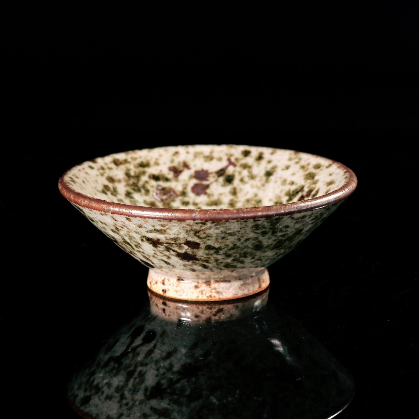 Jingdezhen wood-fired douli tea cup with natural ash glaze and fine crackles, showcasing wabi-sabi aesthetic