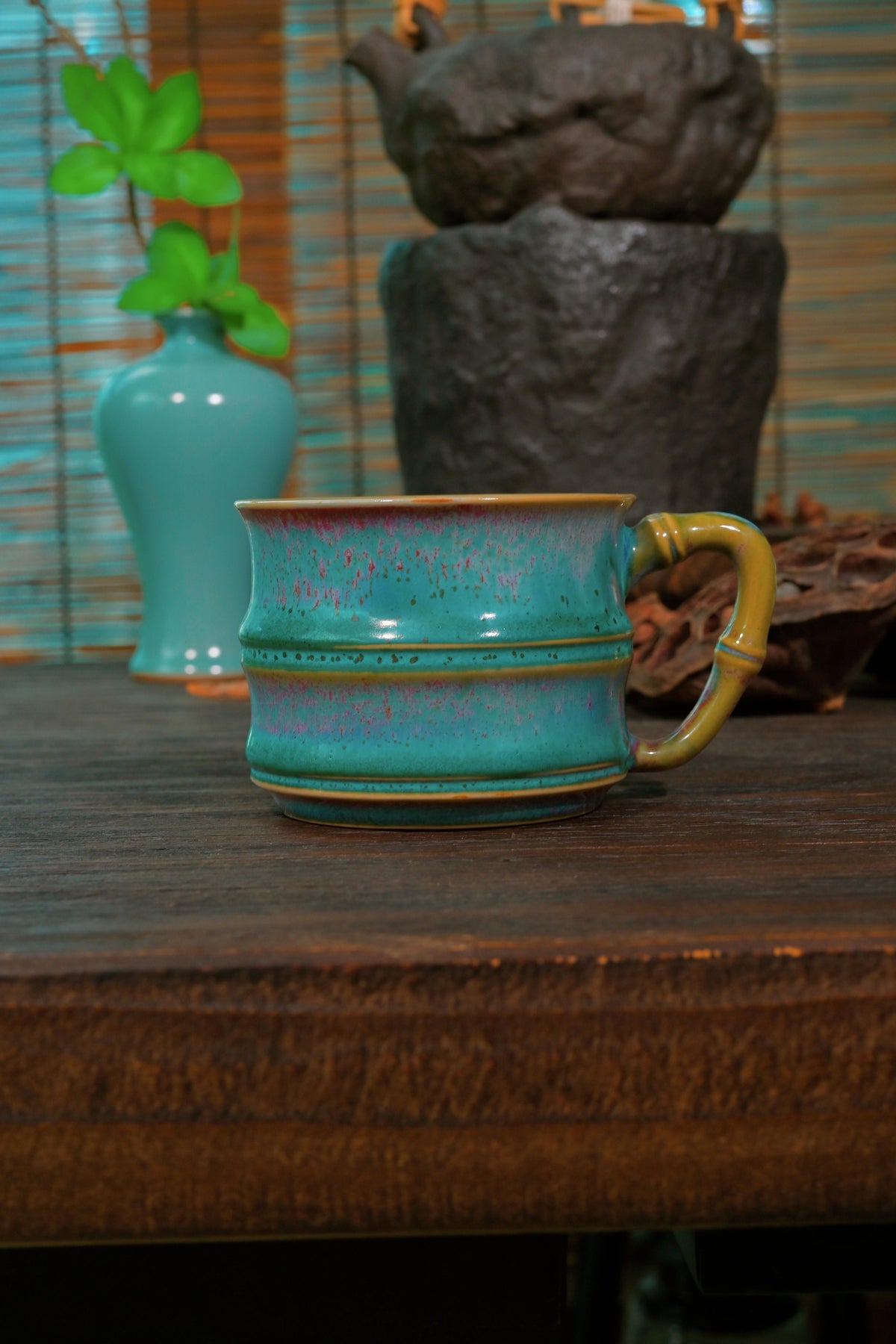 Traditional Chinese Jun Ware master mug by Li Panlong set against dark reflective background