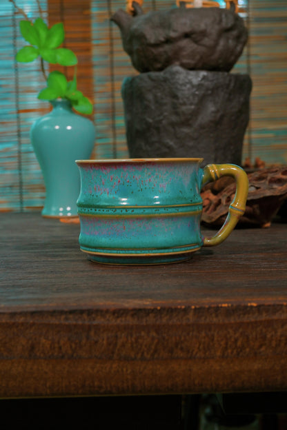 Traditional Chinese Jun Ware master mug by Li Panlong set against dark reflective background