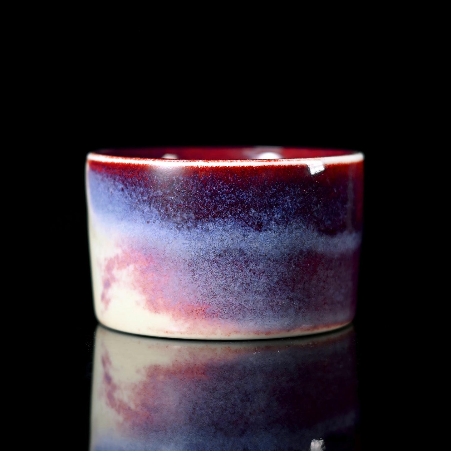 Copper-iron glaze alchemy creating unpredictable color variations through high-temperature wood firing