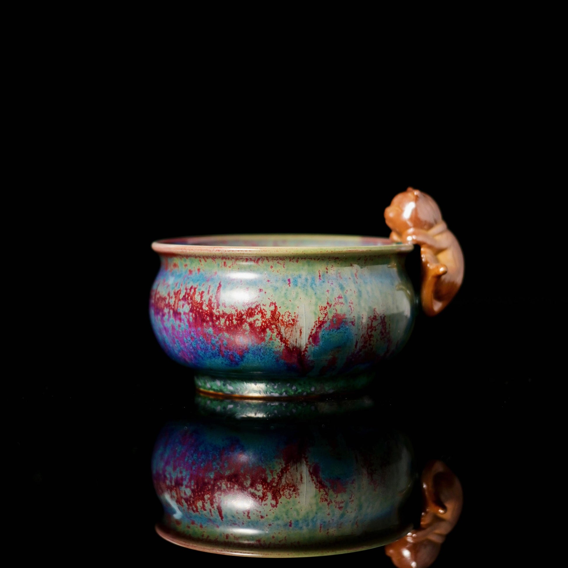 Jun Ware cat-handle master cup featuring kiln-transformed galaxy glaze in red, blue, purple and green
