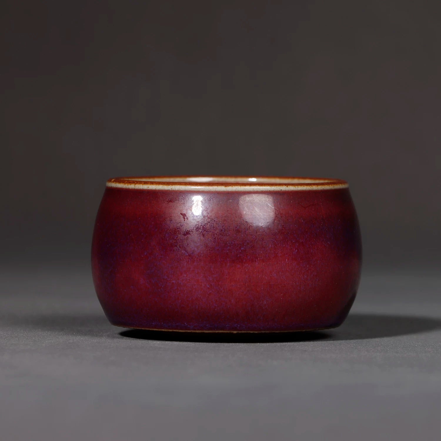 Close-up of the tiny steam vent on the lid and the subtle luster of the porcelain surface.