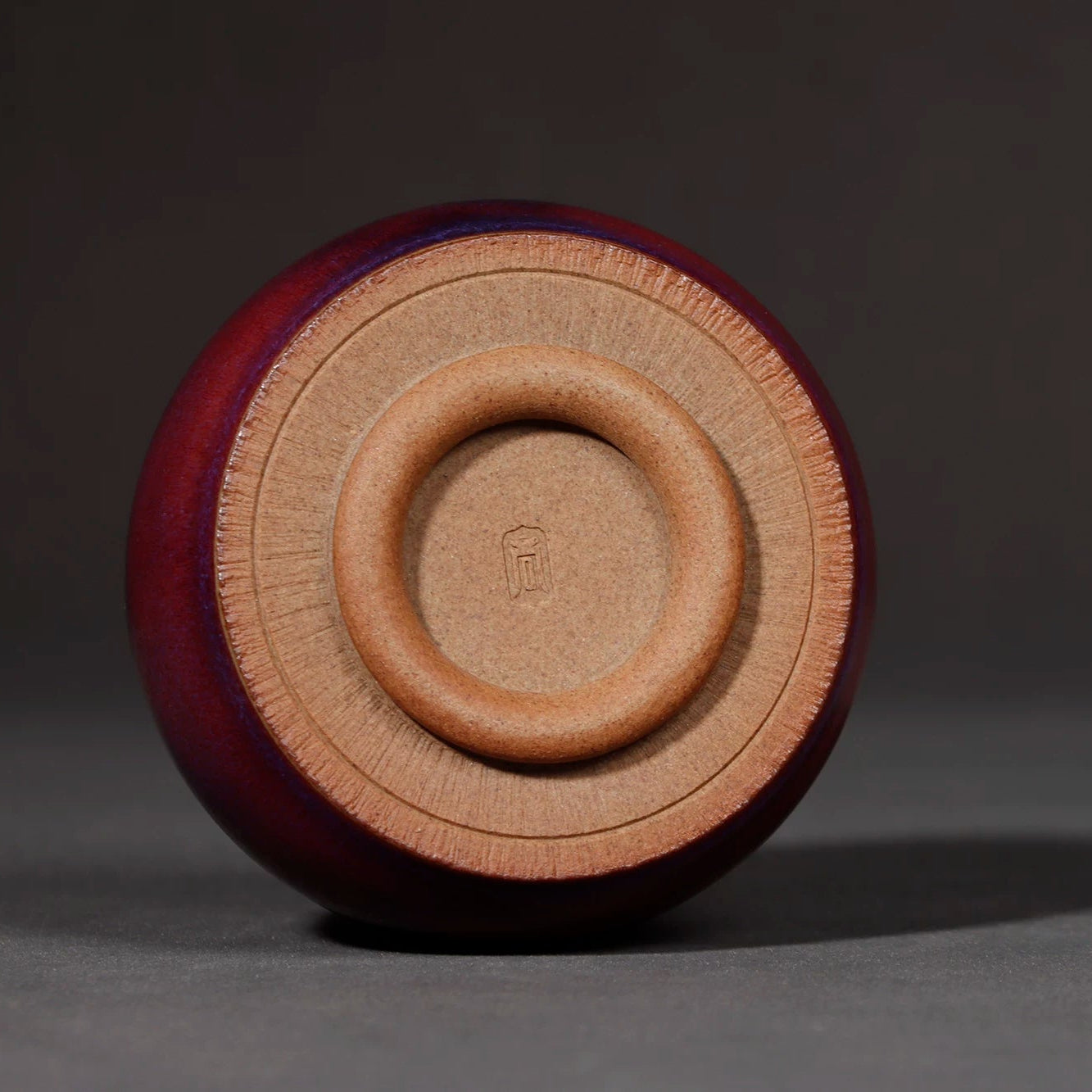 Bottom view showing the classic three-legged base and stamped artisan hallmark.
