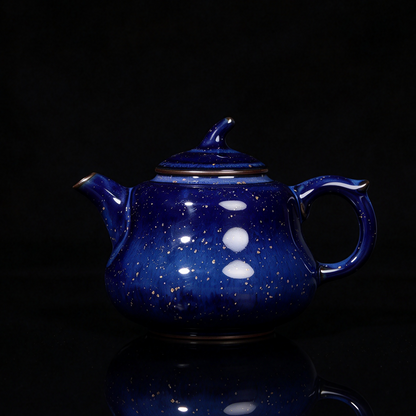 Jun Ware starry blue glaze handcrafted teapot showing crystalline spots on dark background