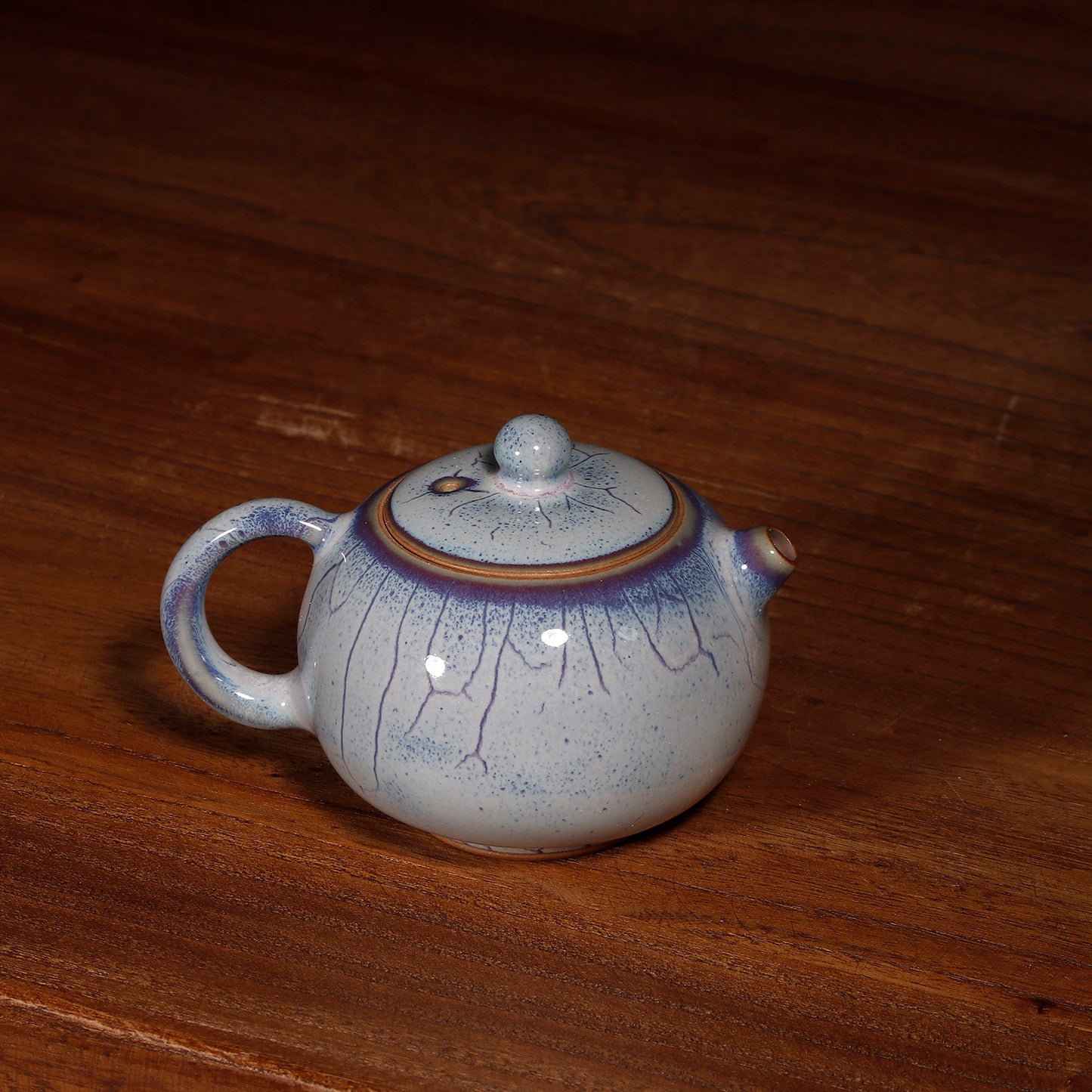 Close-up of Handcrafted Jun Ware teapot glaze, showing the natural blue and purple kiln transformation