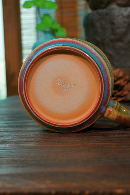 Ergonomic bamboo stalk handle on 180ml Jun Ware peacock glaze mug designed for heat safety