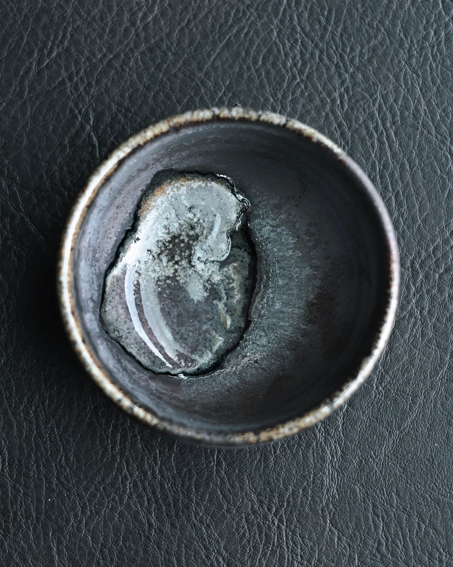 Kiln sweat crystal formation inside cup created during high temperature wood firing