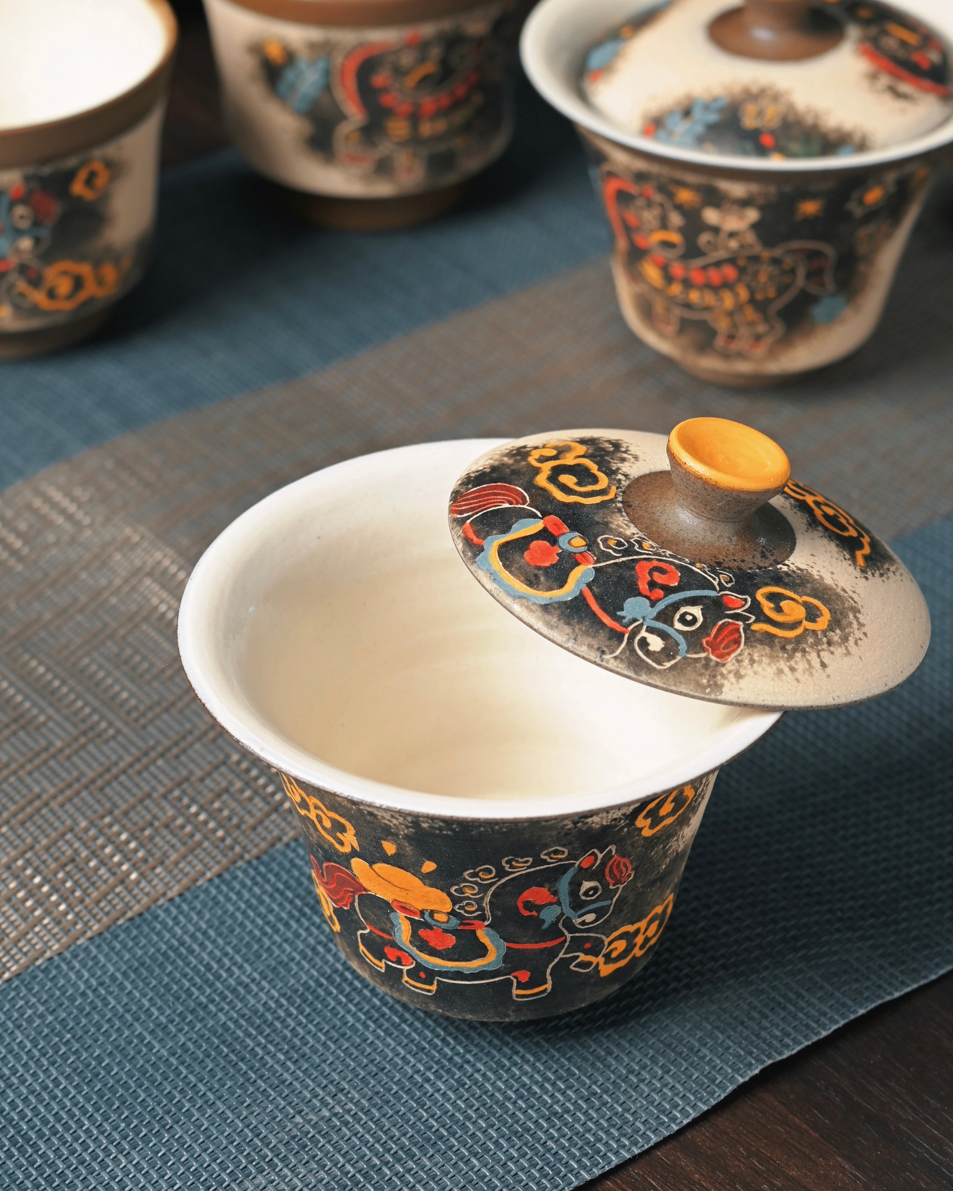 Knife-carved pony outline creating three-dimensional relief effect on Gaiwan surface