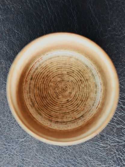 Hand-coiled porcelain cup with detailed Chinese brush painting of birds and blossoms, crafted using traditional Jingdezhen techniques for a nostalgic aesthetic.