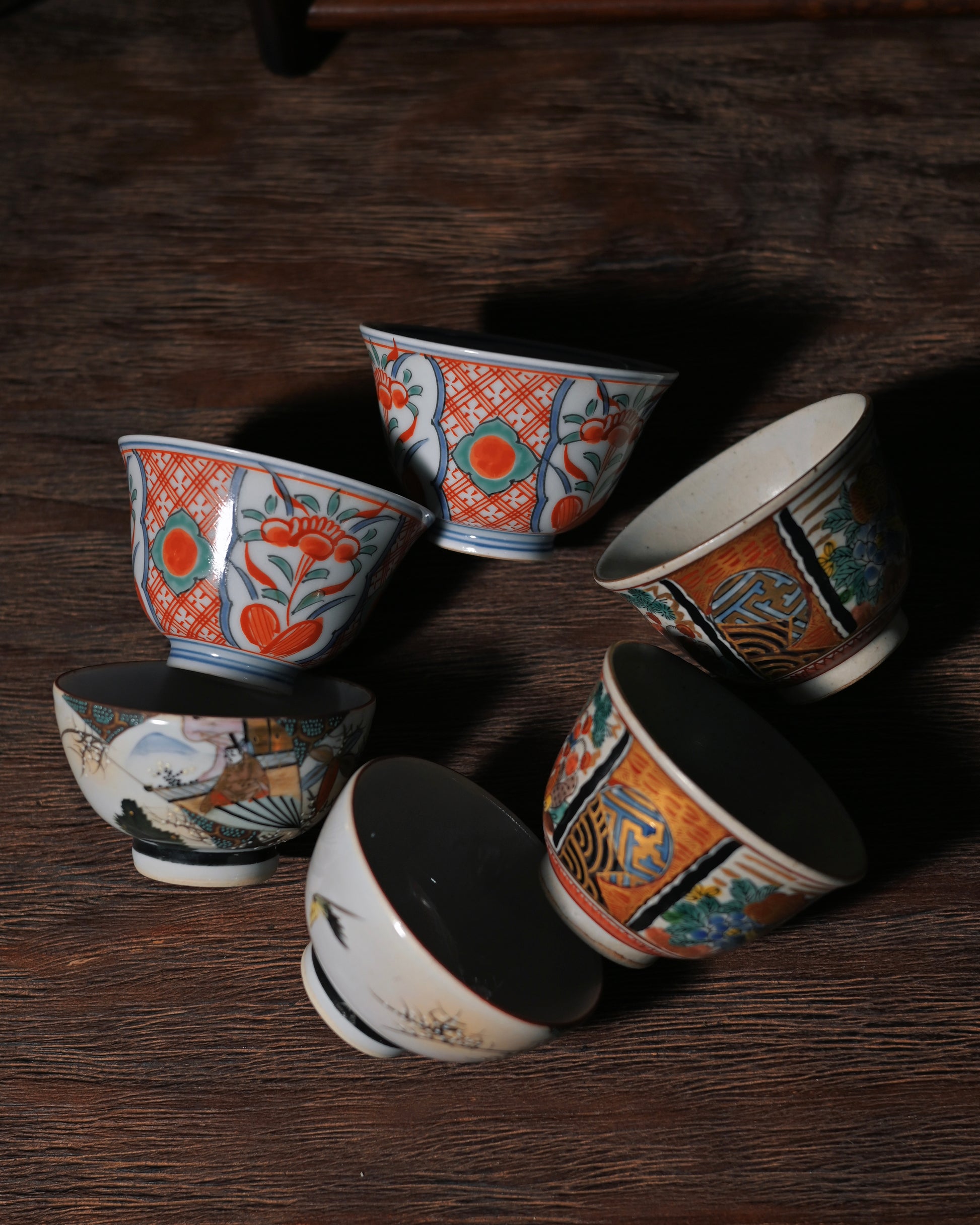 Kutani tea cup featuring a hand-painted ancient Japanese warrior holding a decorative fan, with gold accents and vibrant colors.