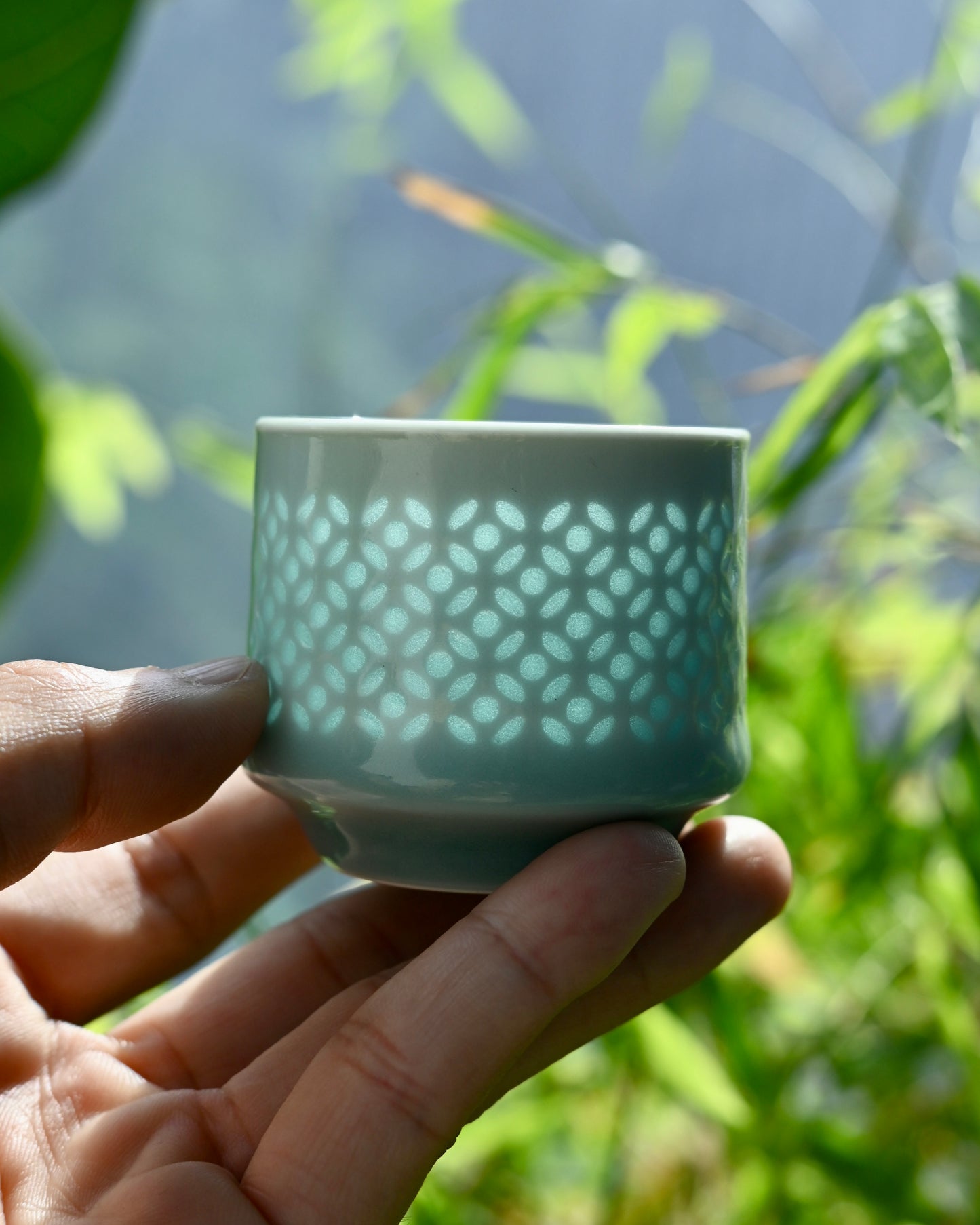 Detailed view of intricate knife-carved hollow patterns filled with transparent glaze