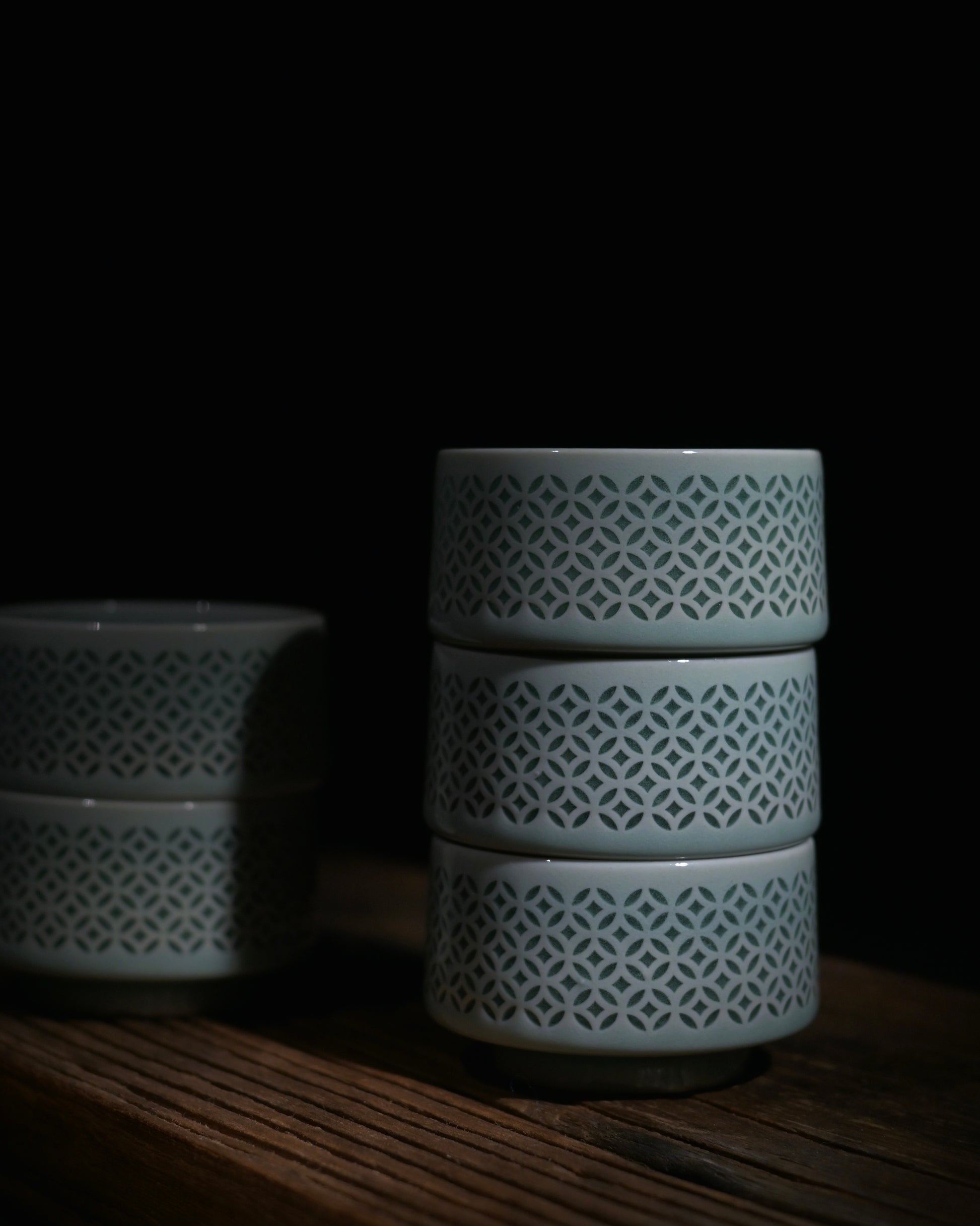 Tall straight body linglong Longquan celadon gongfu tea cup with cloud scroll rim decoration, premium tea tasting cup
