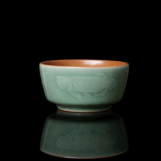 Top view of Longquan Celadon teacup showing the rhythmic hand-chattered "Tiao Dao" texture inside the bowl.
