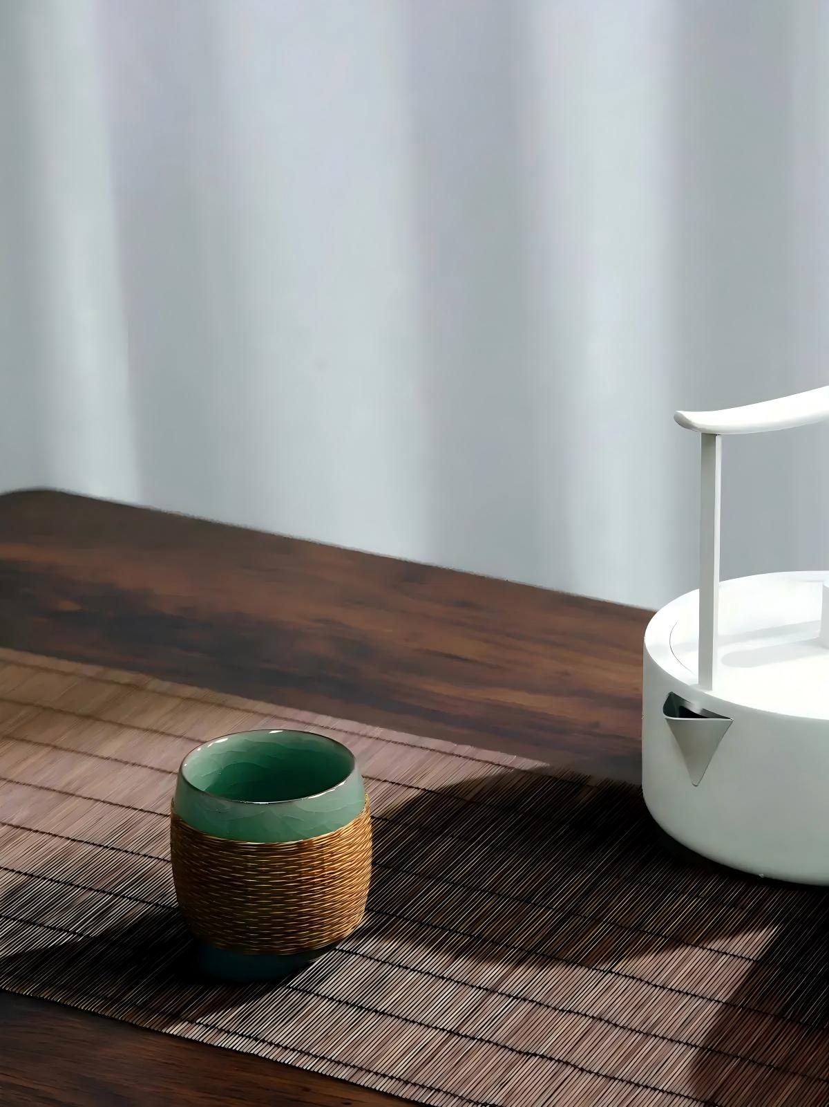 Yuanrong rounded Longquan celadon teacup crafted with Sichuan hand‑woven bamboo sleeve, oriental tea utensil