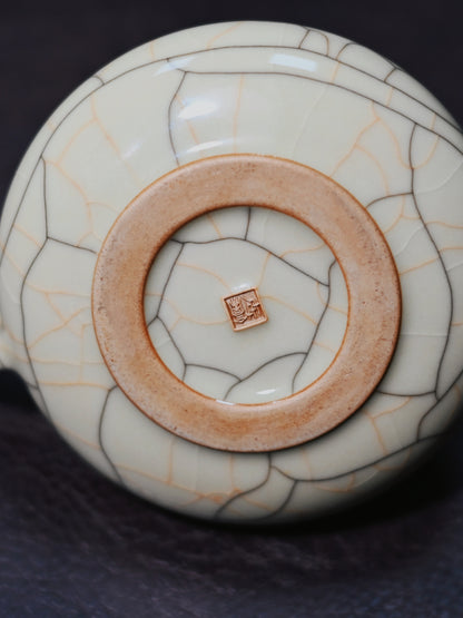 Iron-body Shippiao teapot in Longquan Ge-style celadon with intentional crackle patterns, hand-built and fired for hydrodynamic pouring performance